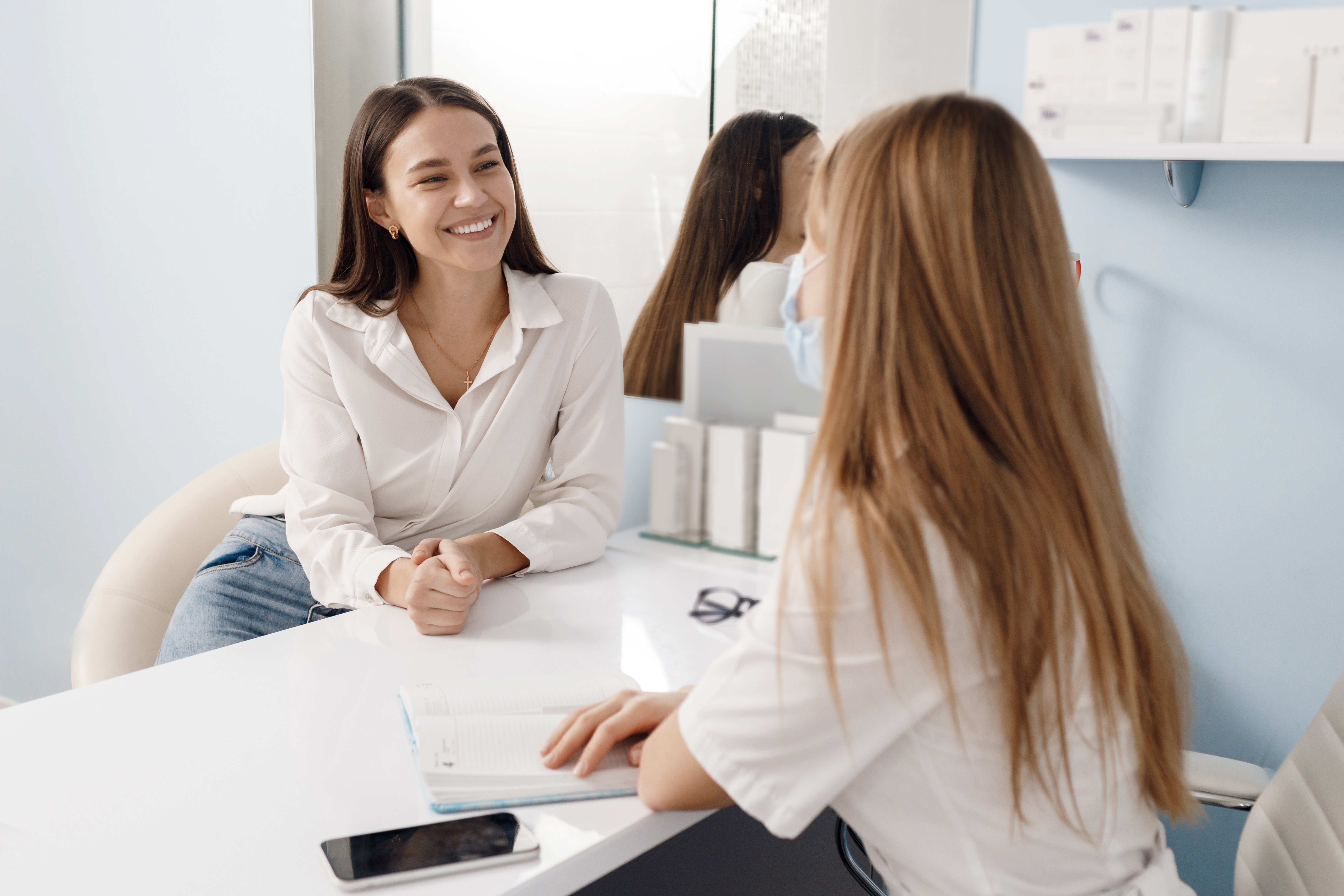 Woman having a botox consultation with a professional